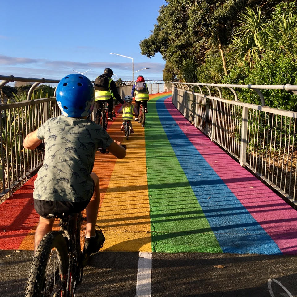 A family biking on the rainbow path